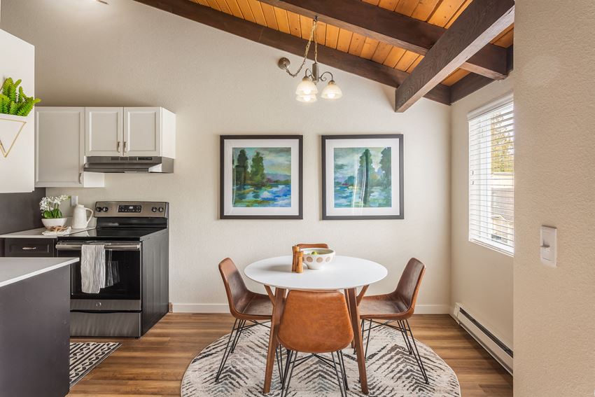 a kitchen and dining room with a table and chairs
