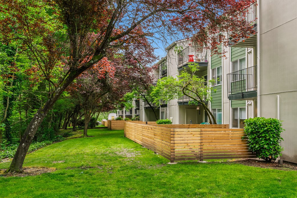 a wooden retaining wall in front of an apartment building