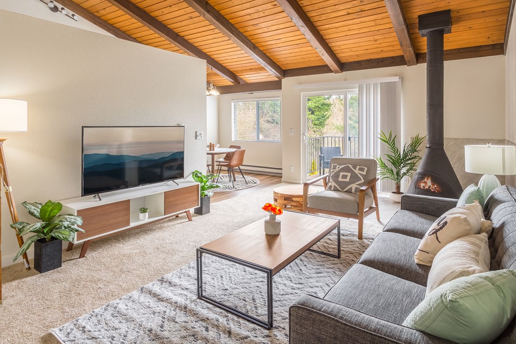 a living room with a couch and a coffee table and a fireplace