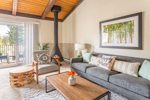 a living room with a couch and a coffee table and a fireplace