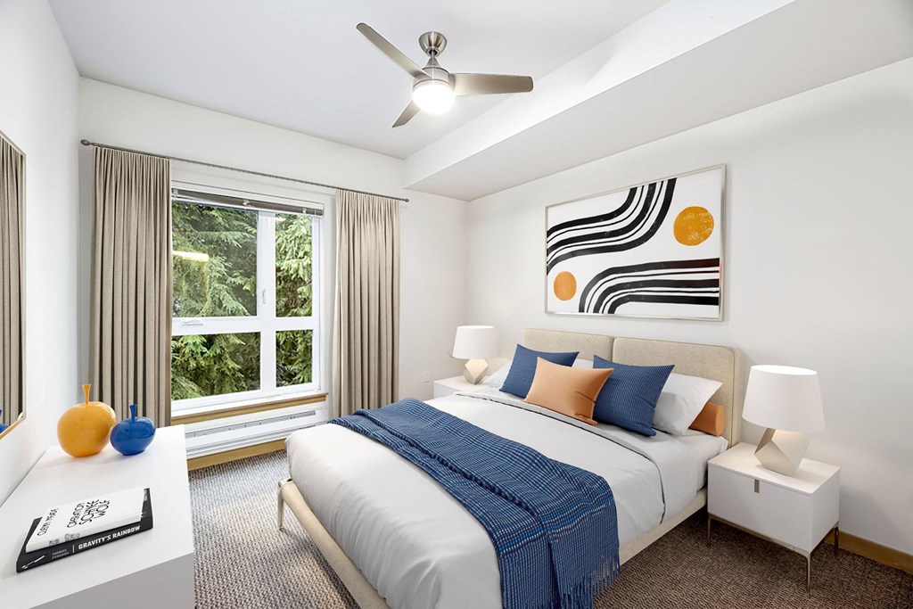 a bedroom with a bed and a ceiling fan