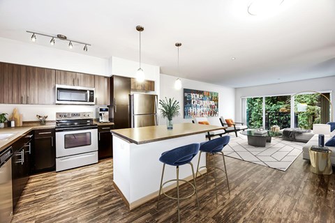 a kitchen and living room with a table and chairs