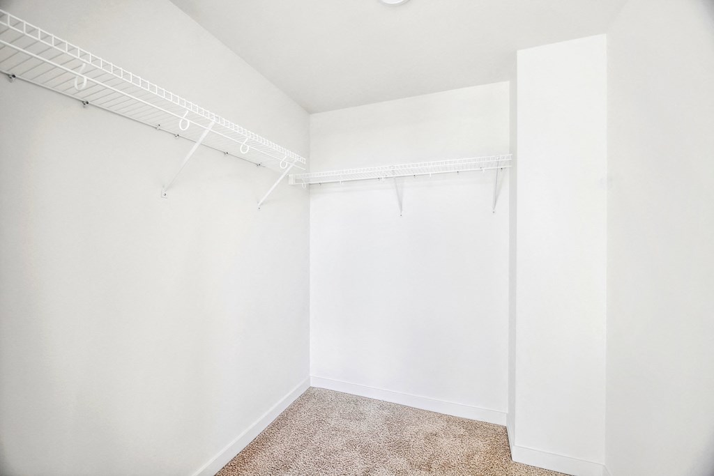 an empty room with white walls and a closet