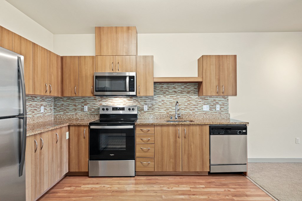 a kitchen with wooden cabinets and stainless steel appliances
