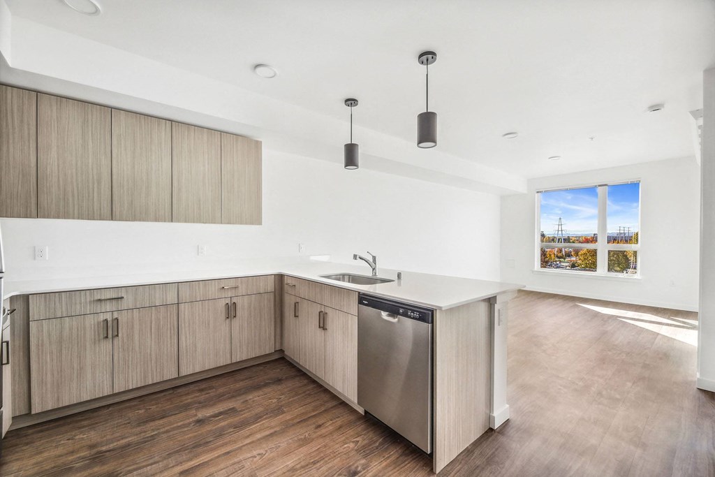 an empty kitchen with wooden floors and wooden cabinets