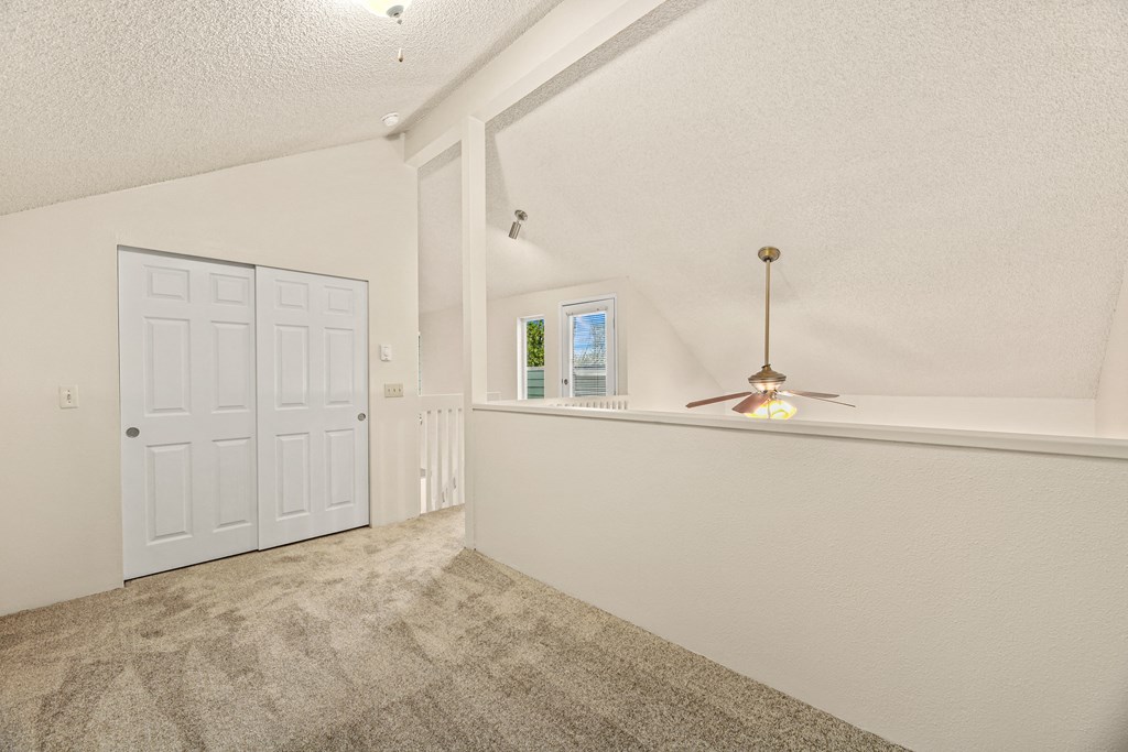 the living room and entryway of a house with a white door