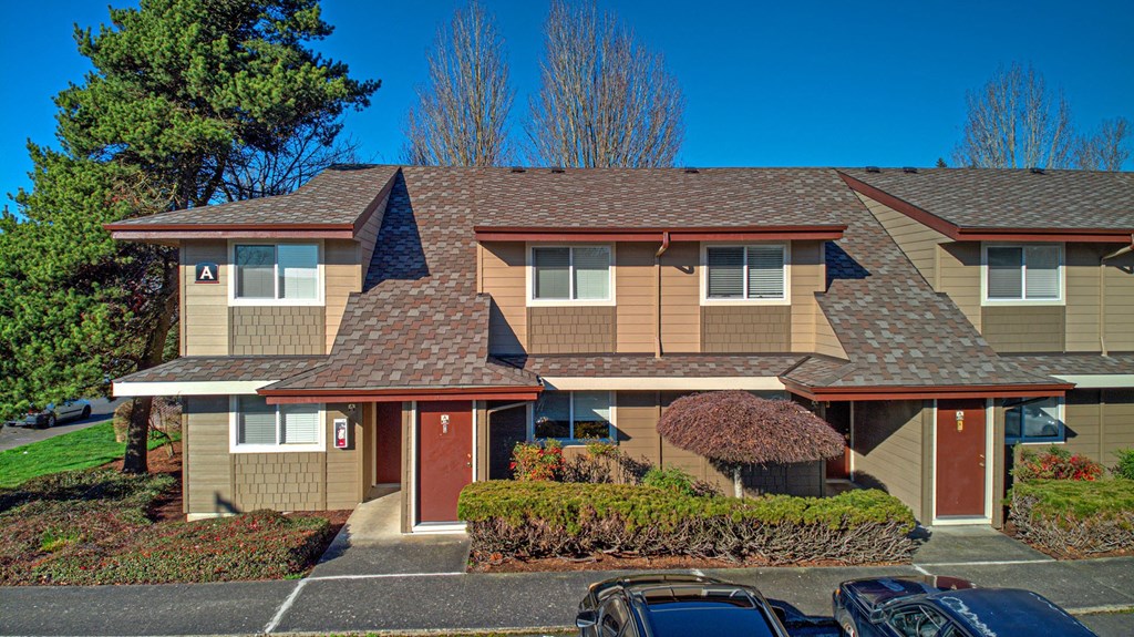 a large house with a parking lot in front of it