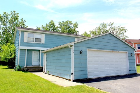A blue house with a white garage door.