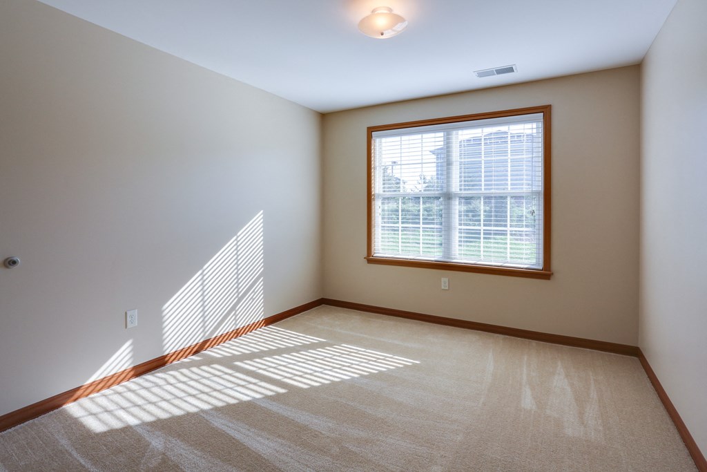 an empty living room with a large window