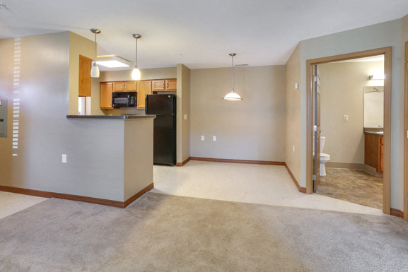 A kitchen area with a microwave and oven built into the cabinetry.