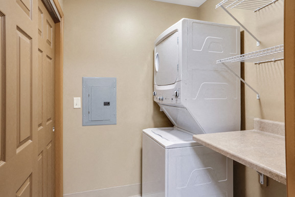 A white dishwasher and dryer in a small kitchen.