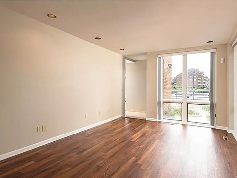 A room with wooden floors and a sliding glass door.