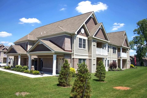 A large house with a grey roof and white trim.