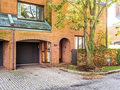 A red brick house with a black garage door.