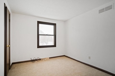 A room with a window and a door.