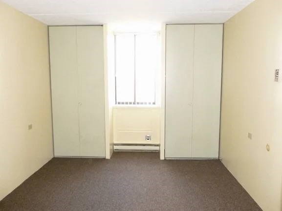 A room with a window and a radiator on the wall.