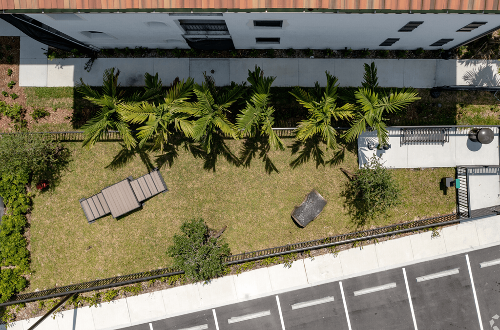 an overhead view of a yard in front of a building