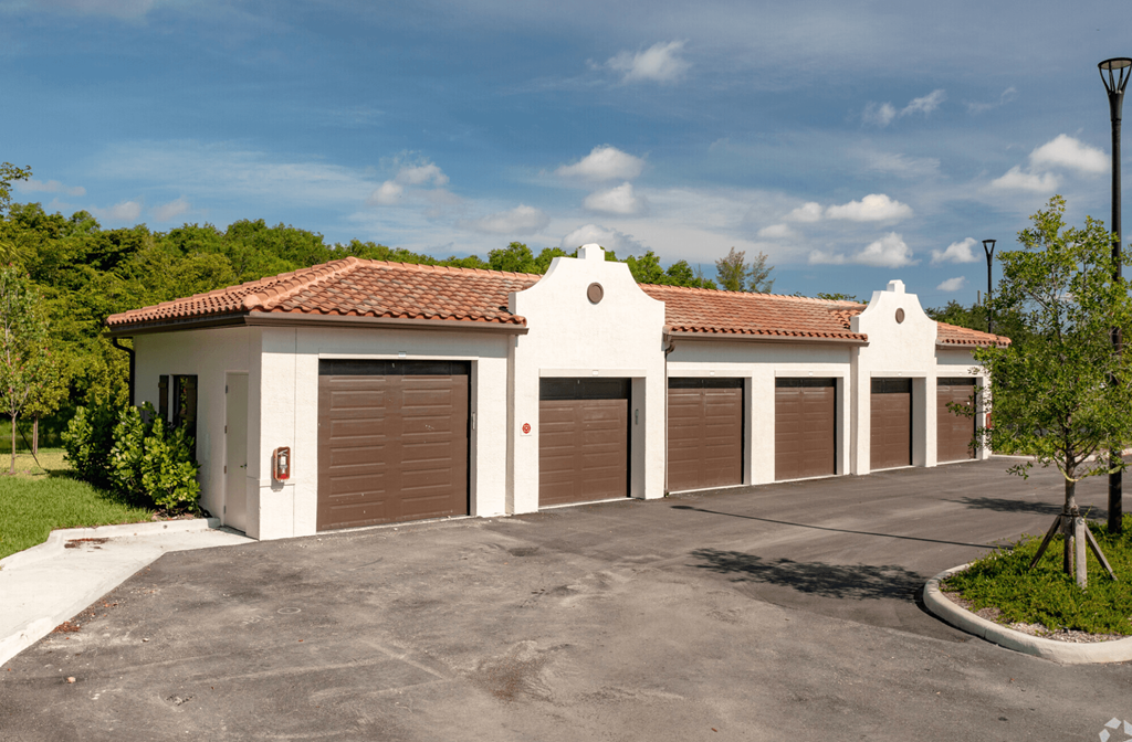 a group of garages in a row with a blue sky in the background