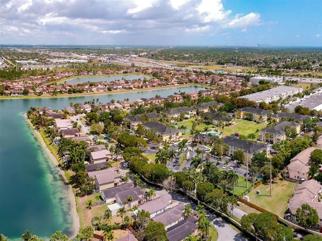 an aerial view of a neighborhood with a body of water