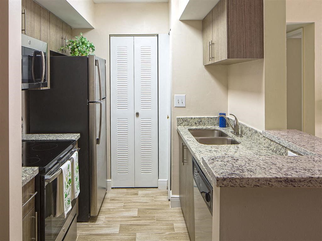 a kitchen with a sink and a refrigerator