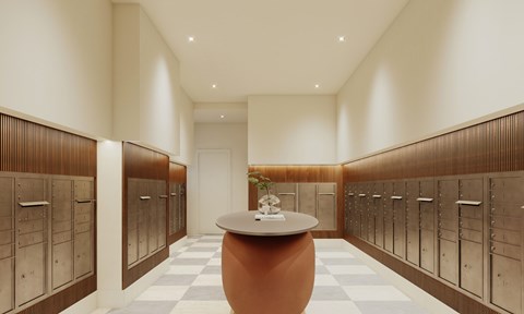 A hallway with a round table in the middle and lockers on both sides.
