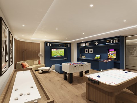 A room with a pool table and a foosball table.