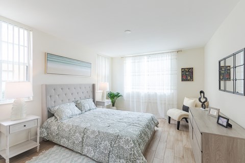 a bedroom with a bed and a desk
