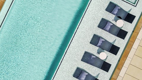 A blue pool with a white line down the middle and a black and white striped pool in the background.