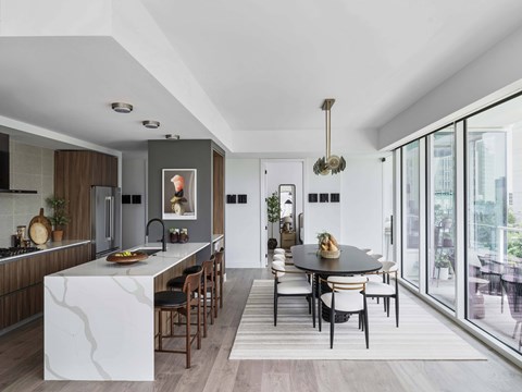 A modern kitchen with a dining table and chairs.