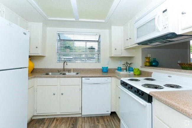 a kitchen with white appliances and white cabinets