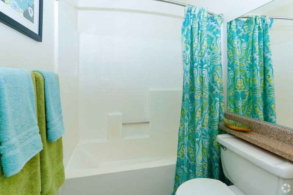 a bathroom with a toilet and a shower curtain