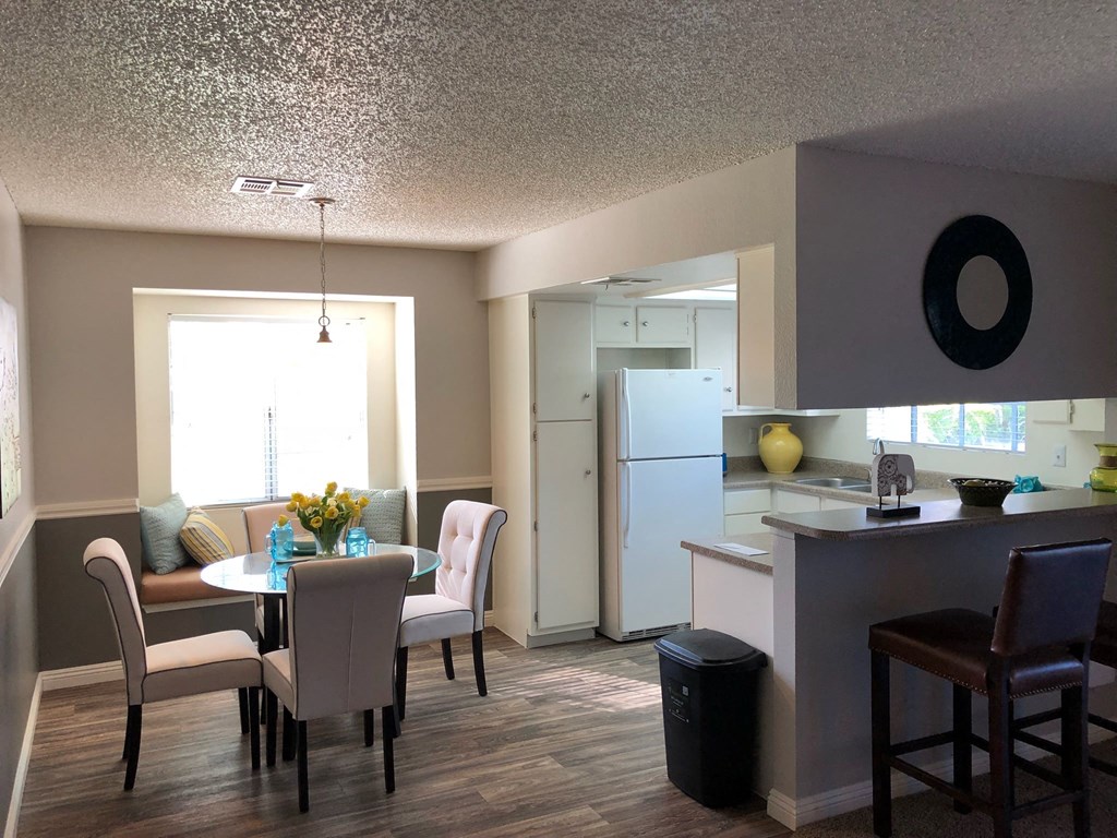a dining room and kitchen with a table and chairs