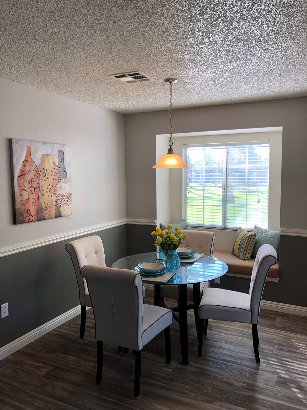 a dining room with a table and chairs and a window