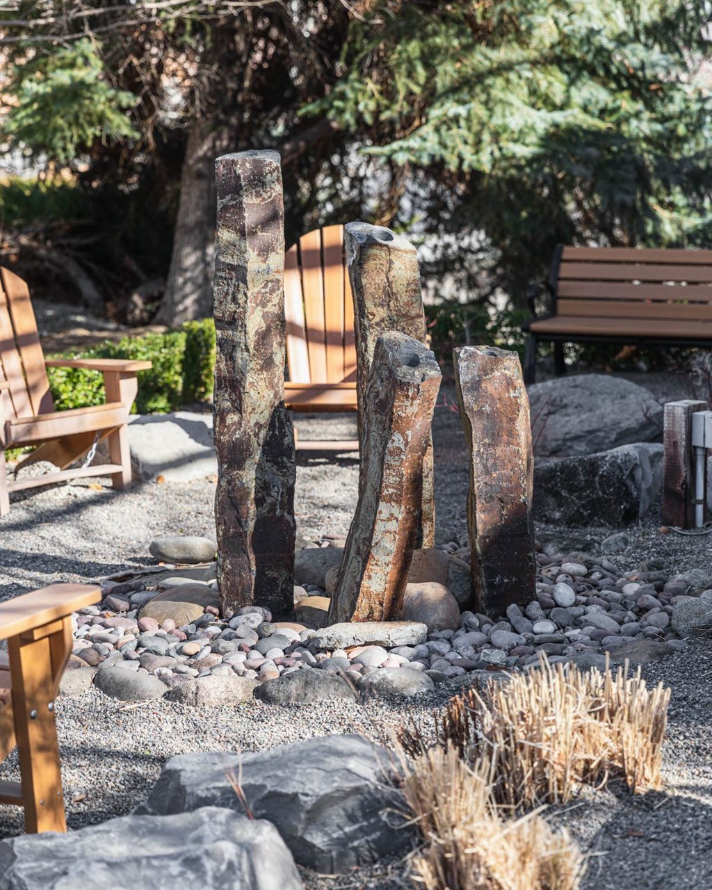 a fountain made out of rocks in a garden