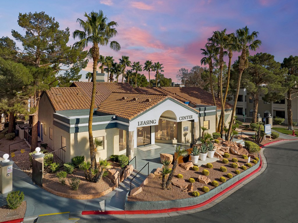 an aerial view of a building with palm trees