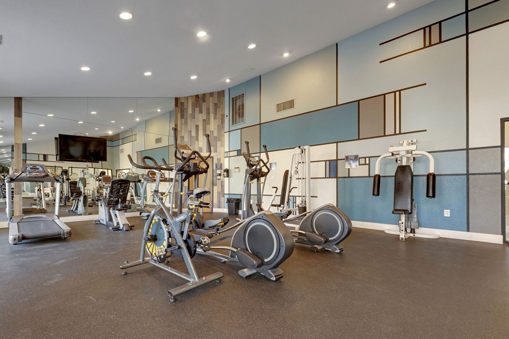 a gym with cardio machines and other exercise equipment