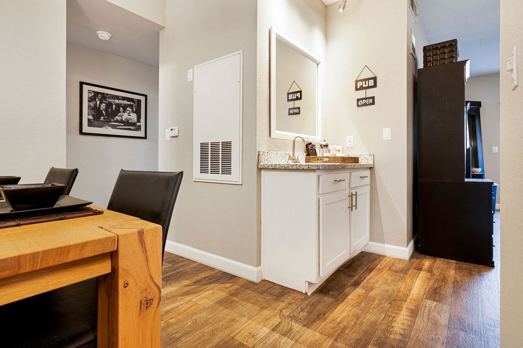 a kitchen and dining room with a refrigerator and a table