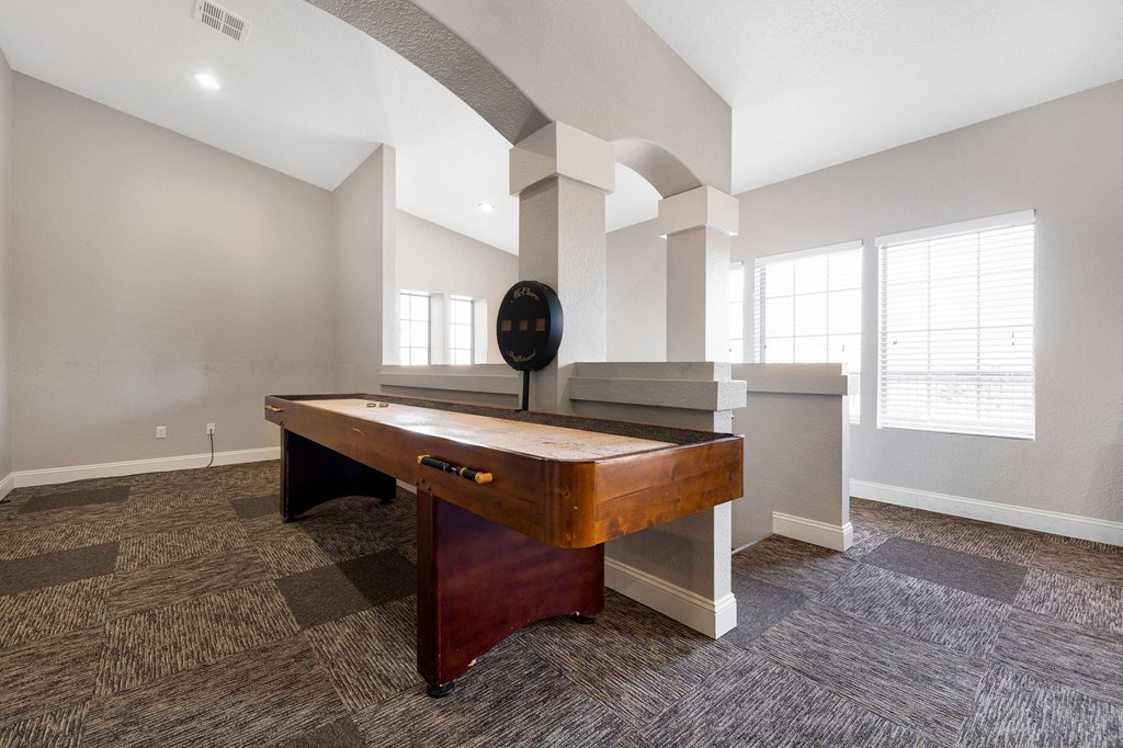 a game room with a pool table and a large window