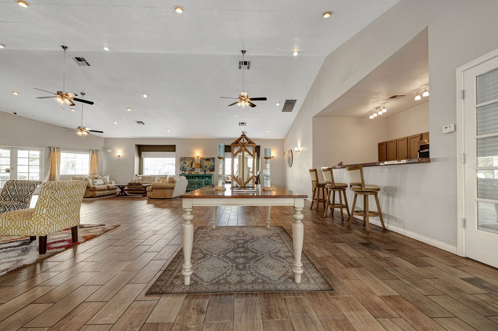 a living room with a dining room table and a kitchen