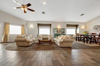 the living room of a house with couches and a table