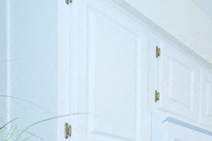 a white kitchen with white cabinets and a counter top