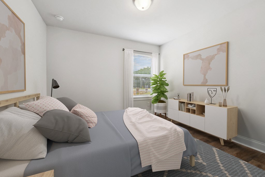 Secondary bedroom with queen size bed and large window letting in a ton of natural light.