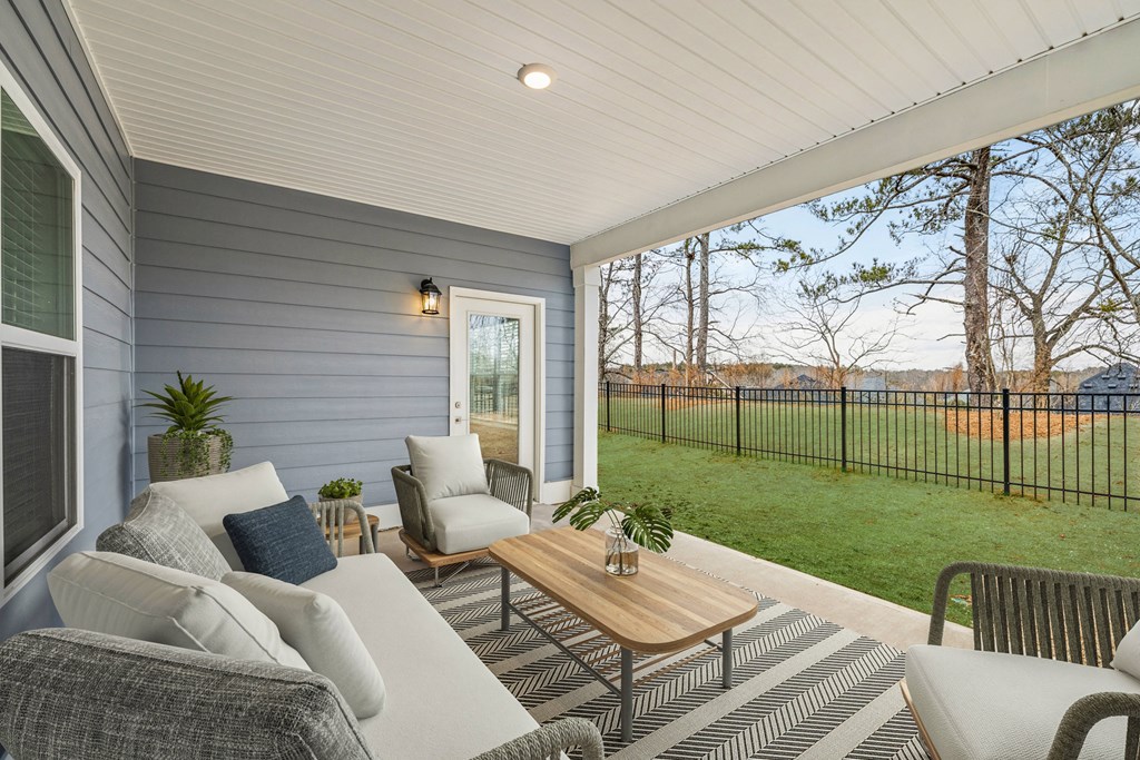 Private covered patio overlooking a fenced backyard.