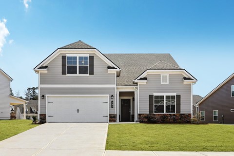 A two-story house with a garage and a driveway.
