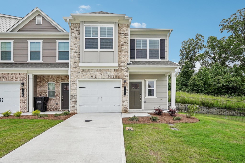 Exterior shot of Waterford layout, two story townhome with a private driveway and attached garage.