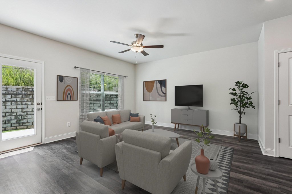 Bright living room featuring a large window that fills the space with natural light.