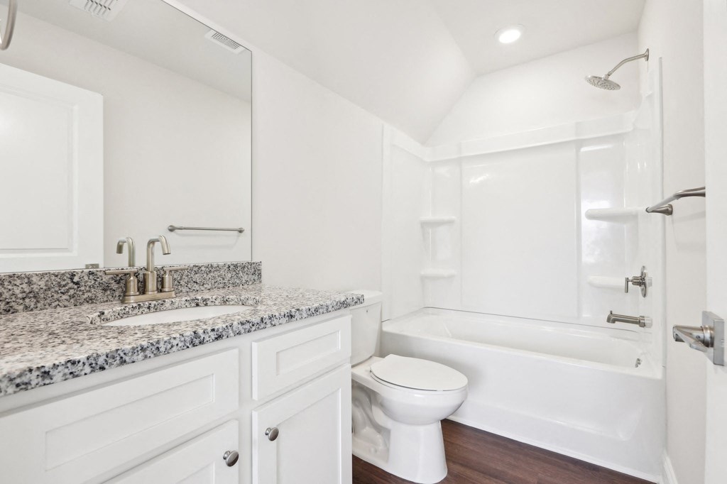 Secondary bathroom with tub shower and single vanity.