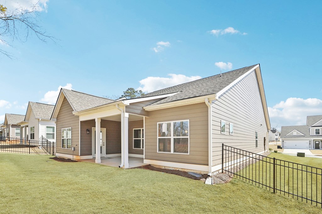 Covered back patio with fenced in yard.