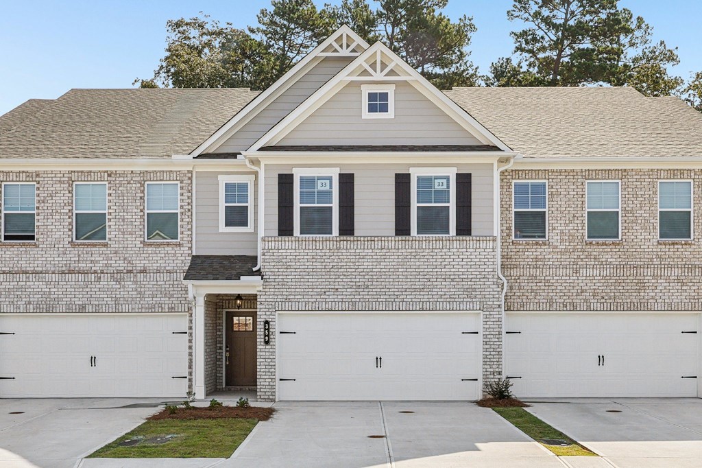 Exterior shot of the Westport floorplan, two story townhome with a private driveway and attached garage.
