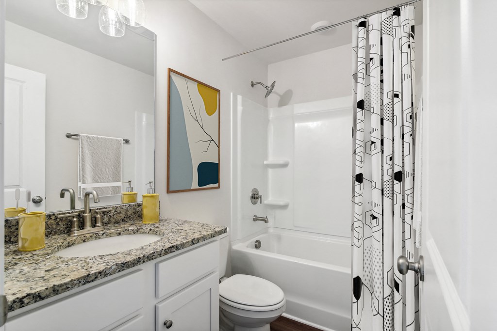 Secondary suite bathroom with a tub and shower combination